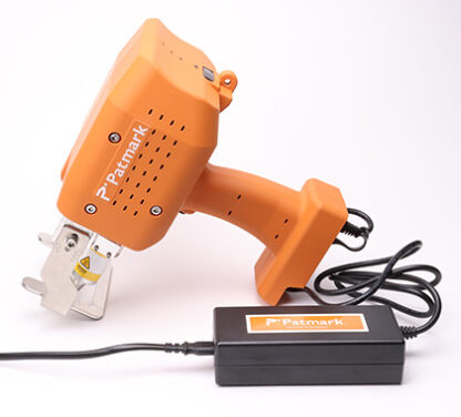 A product image of the orange Patmark-plus lying on the ground with adapter