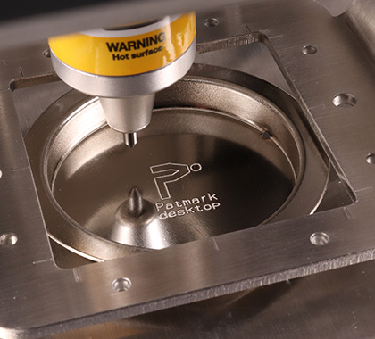 Image of the Patmark logo and the text 'Patmark desktop' engraved on the surface of a steel using Patmark-desktop.