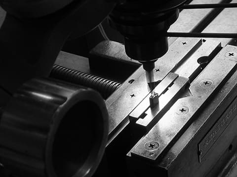 Close-up of a machine drilling a hole.